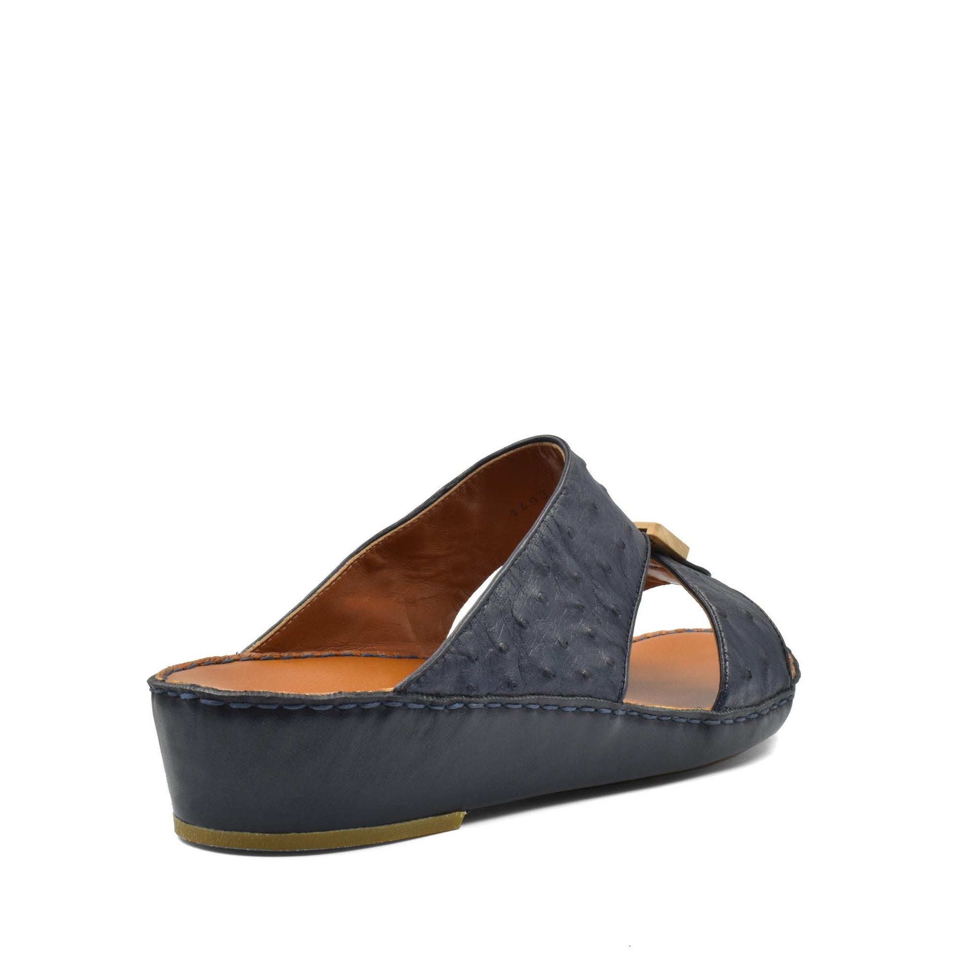 Side view of handcrafted olive sandals in dark textured leather with brown cushioned insole