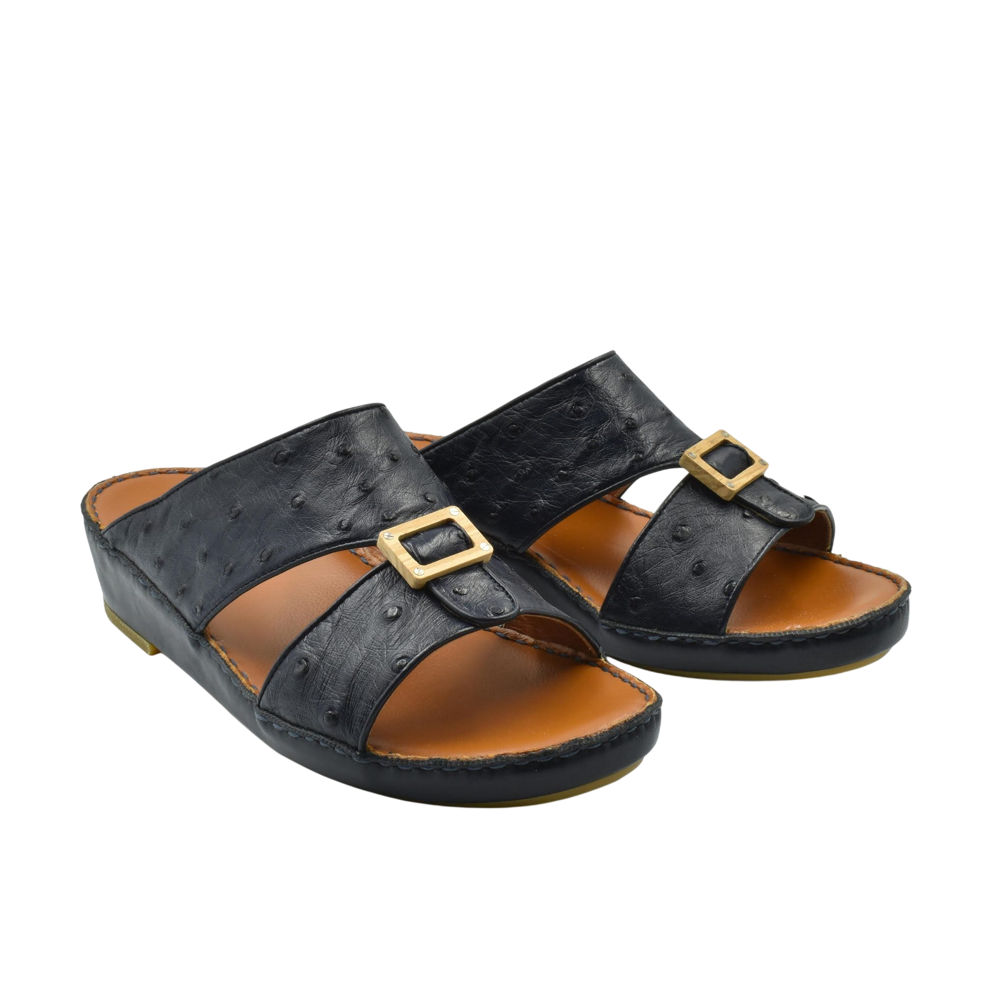 Black handcrafted olive sandals with gold buckle detail and comfortable brown footbed