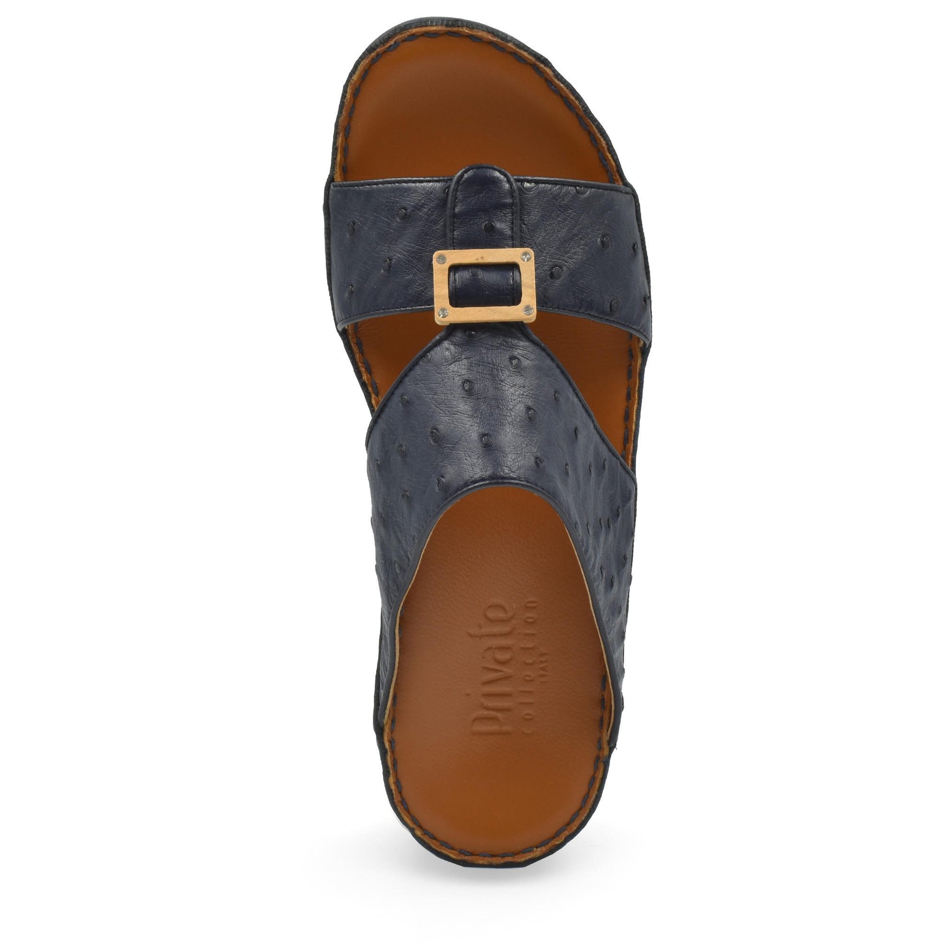 Top view of black leather handcrafted olive sandals with buckle strap and tan footbed