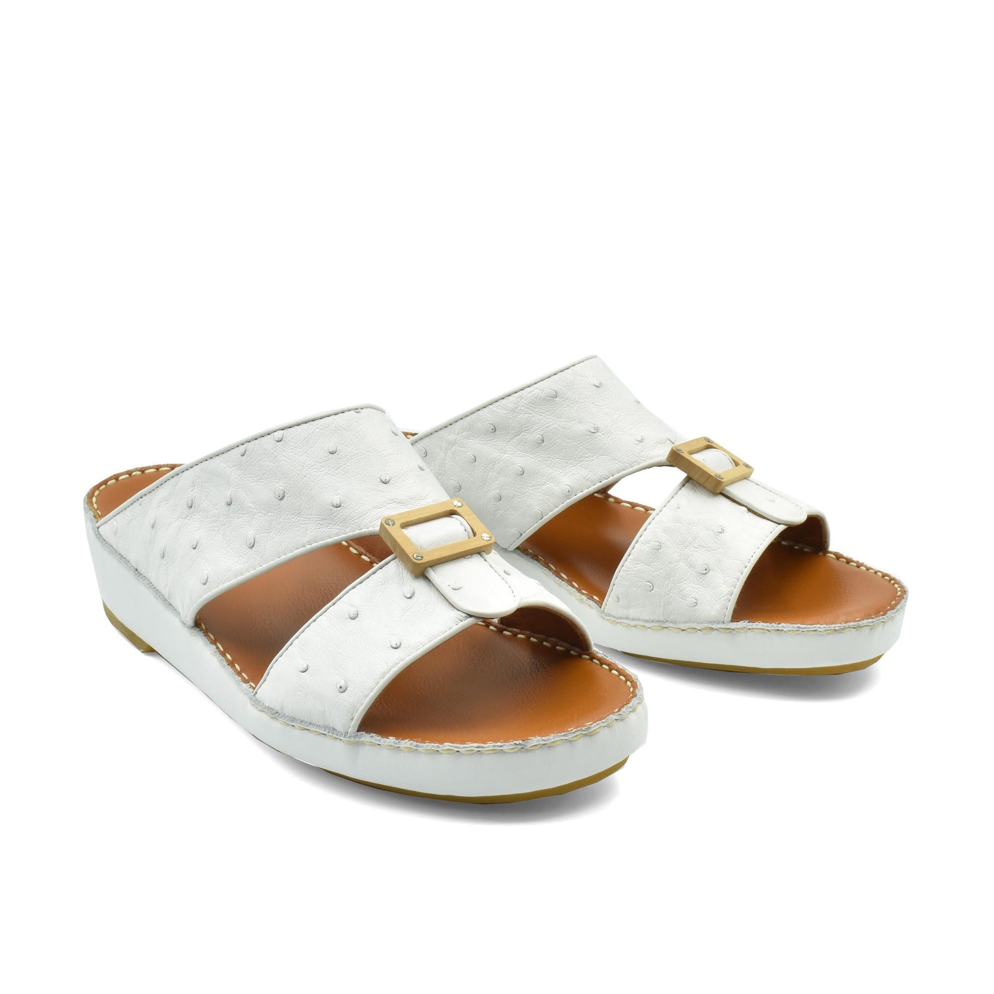 Handcrafted olive sandals in white with buckle detail and cushioned brown footbed for comfortable wear