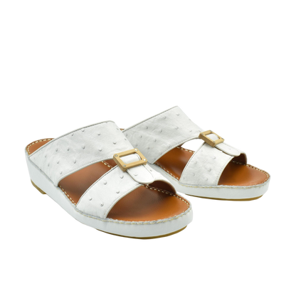 Handcrafted olive sandals in white with buckle detail and cushioned brown footbed for comfortable wear