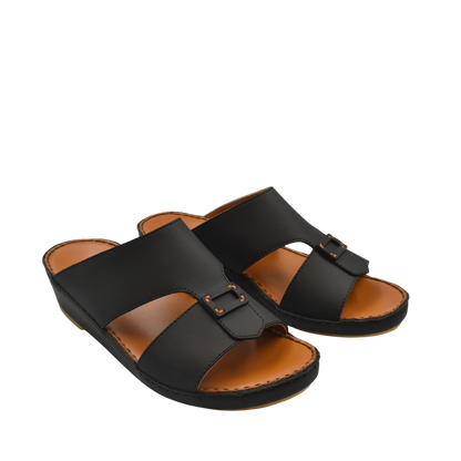 Black Italian leather sandals with buckle detail and tan cushioned footbed from private collection