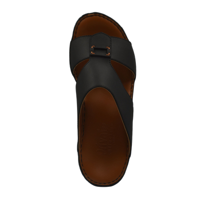 Black Italian leather sandals with buckle strap and brown cushioned sole from Private collection