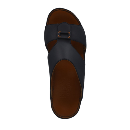 Black Italian leather sandals with buckle detail and brown cushioned footbed in a top view