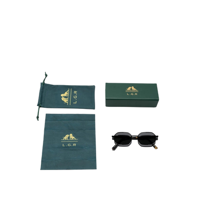 Black matte octagonal sunglasses with branded green case and cleaning cloth by Private Collection