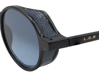Close-up of black sunglasses with blue textured detailing from a luxury eyewear collection