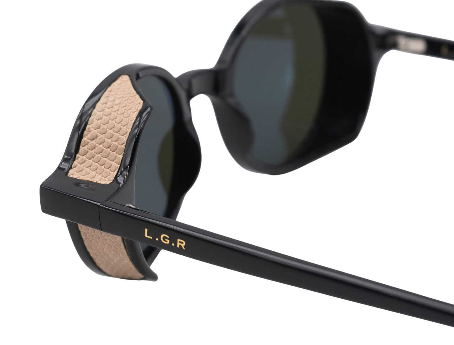 Close-up of black round frame luxury sunglasses with textured beige temple detailing and LGR logo