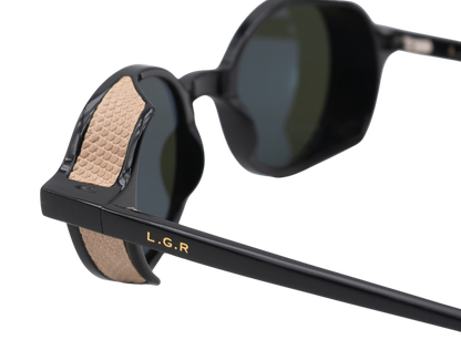 Close-up of black round frame luxury sunglasses with textured beige temple detailing and LGR logo
