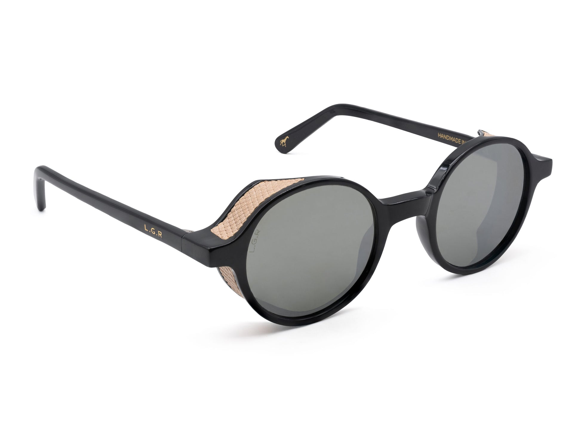 Black round frame luxury sunglasses with textured beige side shields and dark lenses
