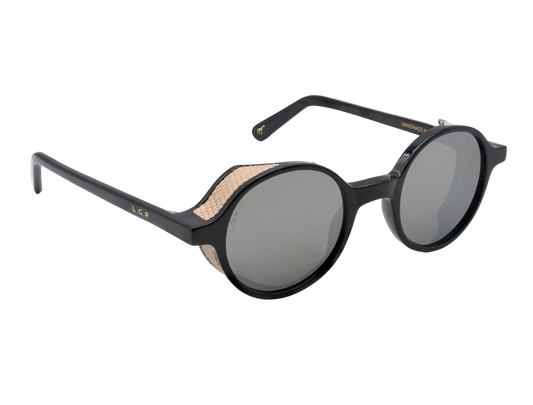 Black round frame luxury sunglasses with textured beige side shields and dark lenses