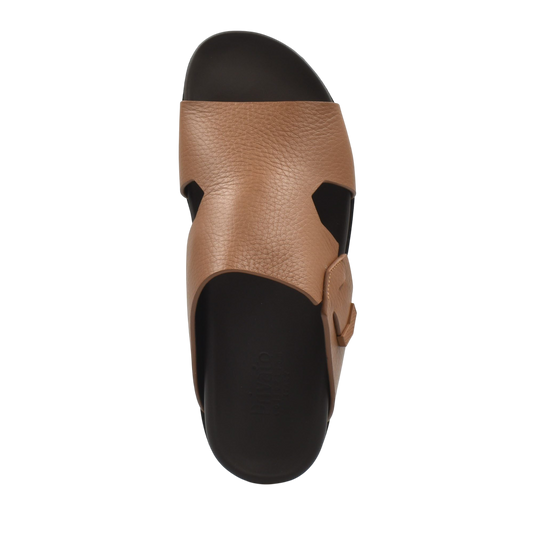 Top view of tan luxury leather sandals with adjustable strap and black sole