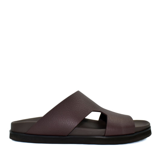 Side view of brown luxury leather sandals with wide straps and cushioned sole