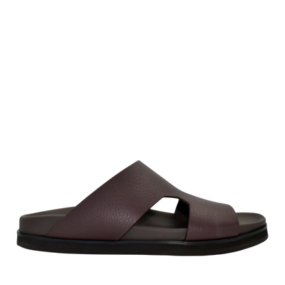 Side view of brown luxury leather sandals with wide straps and cushioned sole