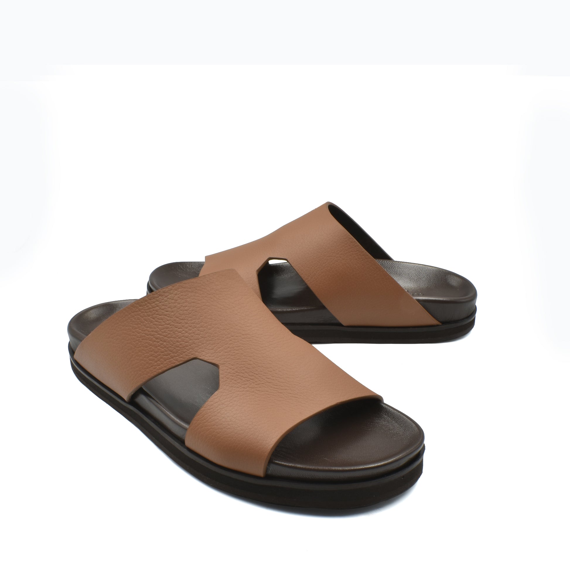 Brown luxury leather sandals with open toe and black cushioned sole for comfortable wear