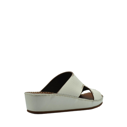 White luxury leather slide sandals with open toe and cushioned wedge sole