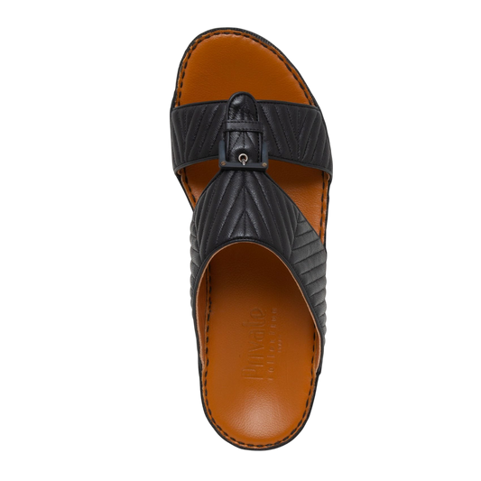 Black luxury matelasse footwear slide sandal with quilted leather straps and brown cushioned footbed