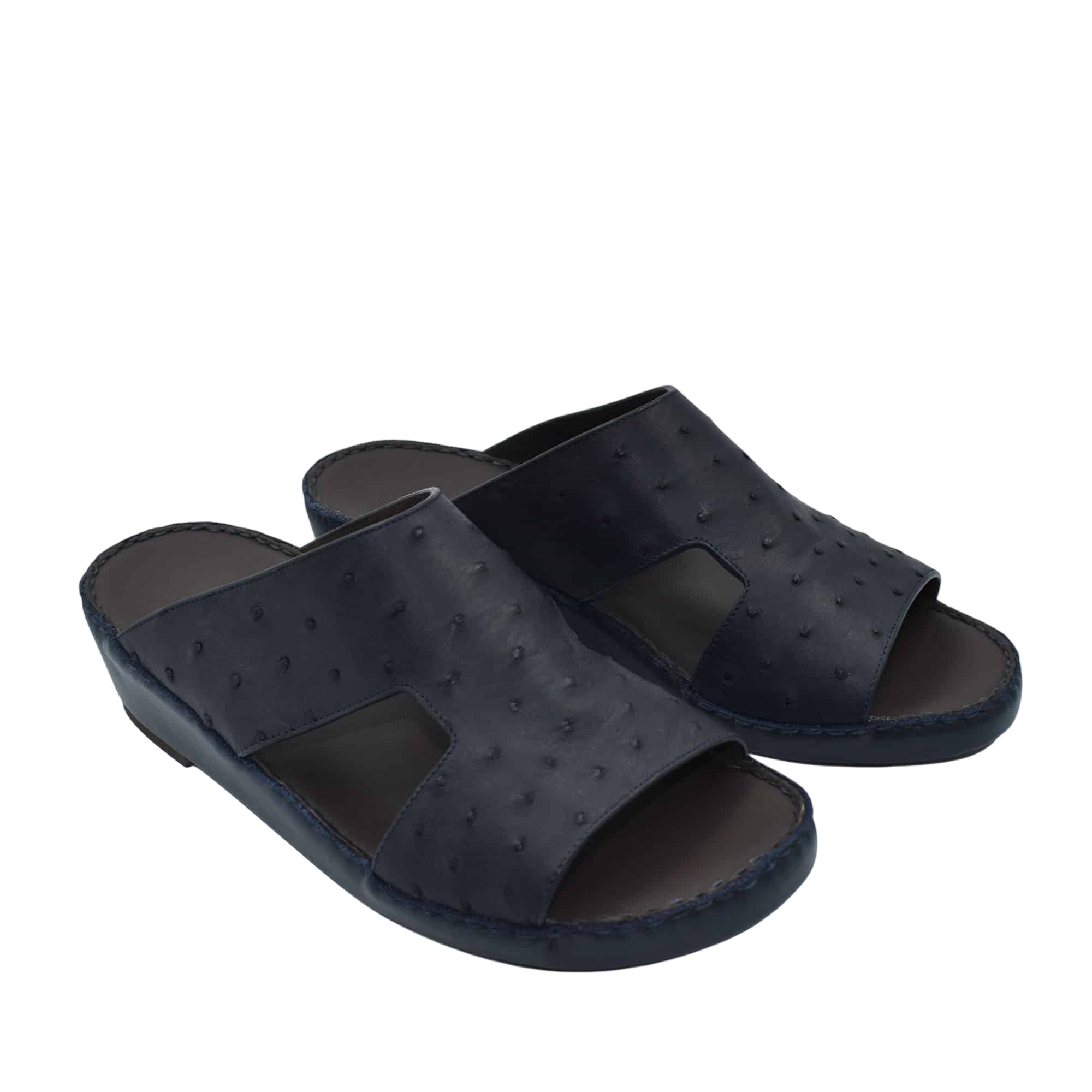 Pair of black luxury ostrich sandals with open toe design and textured leather upper