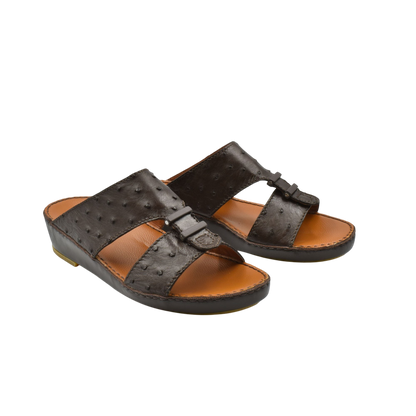 Pair of brown luxury ostrich sandals with textured leather straps and cushioned tan footbed