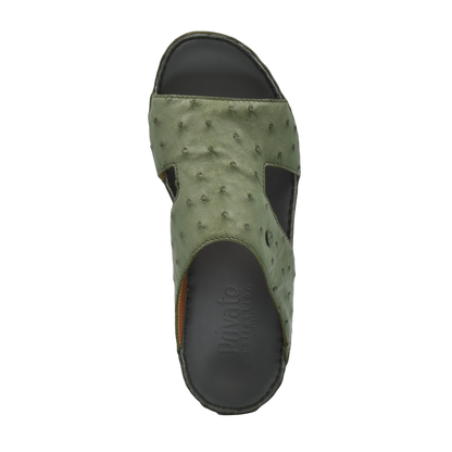 Top view of luxury ostrich sandals in olive green with textured leather and black sole