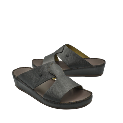 Black leather luxury slip-on footwear with cushioned sole and open toe design