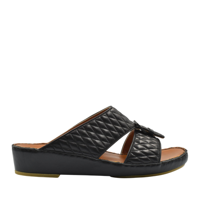 Black quilted luxury slip-on footwear with a bow detail and cushioned sole for comfort