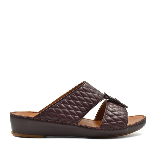 Brown quilted luxury slip-on footwear with cushioned leather sole and open toe design