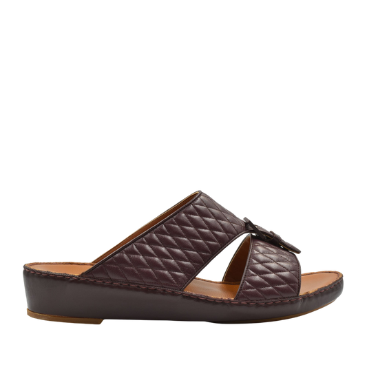 Brown quilted luxury slip-on footwear with cushioned leather sole and open toe design