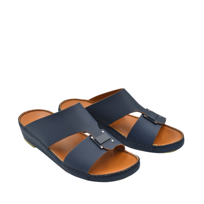 Pair of navy blue Manetta Rubbercalf sandals with adjustable buckle and cushioned tan insole