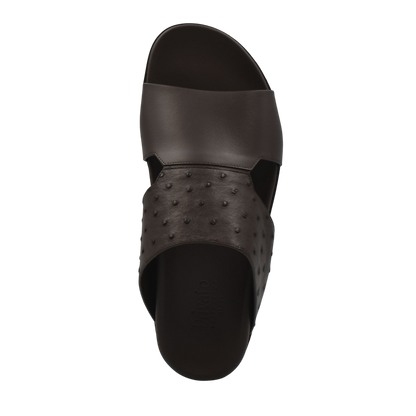 Black slide sandal with smooth and textured design made from ostrich leather footwear
