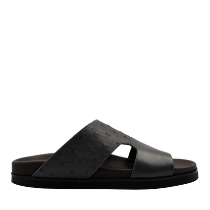 Black slide sandal featuring premium ostrich leather footwear with open toe and comfortable sole