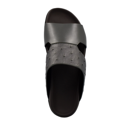 Top view of black ostrich leather footwear slide sandal with textured and smooth straps