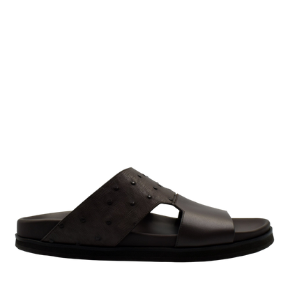 Black slide sandal featuring ostrich leather footwear with textured upper strap from private collection