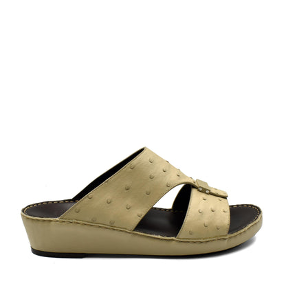 Beige ostrich leather sandals with a slip-on wedge design and textured leather upper