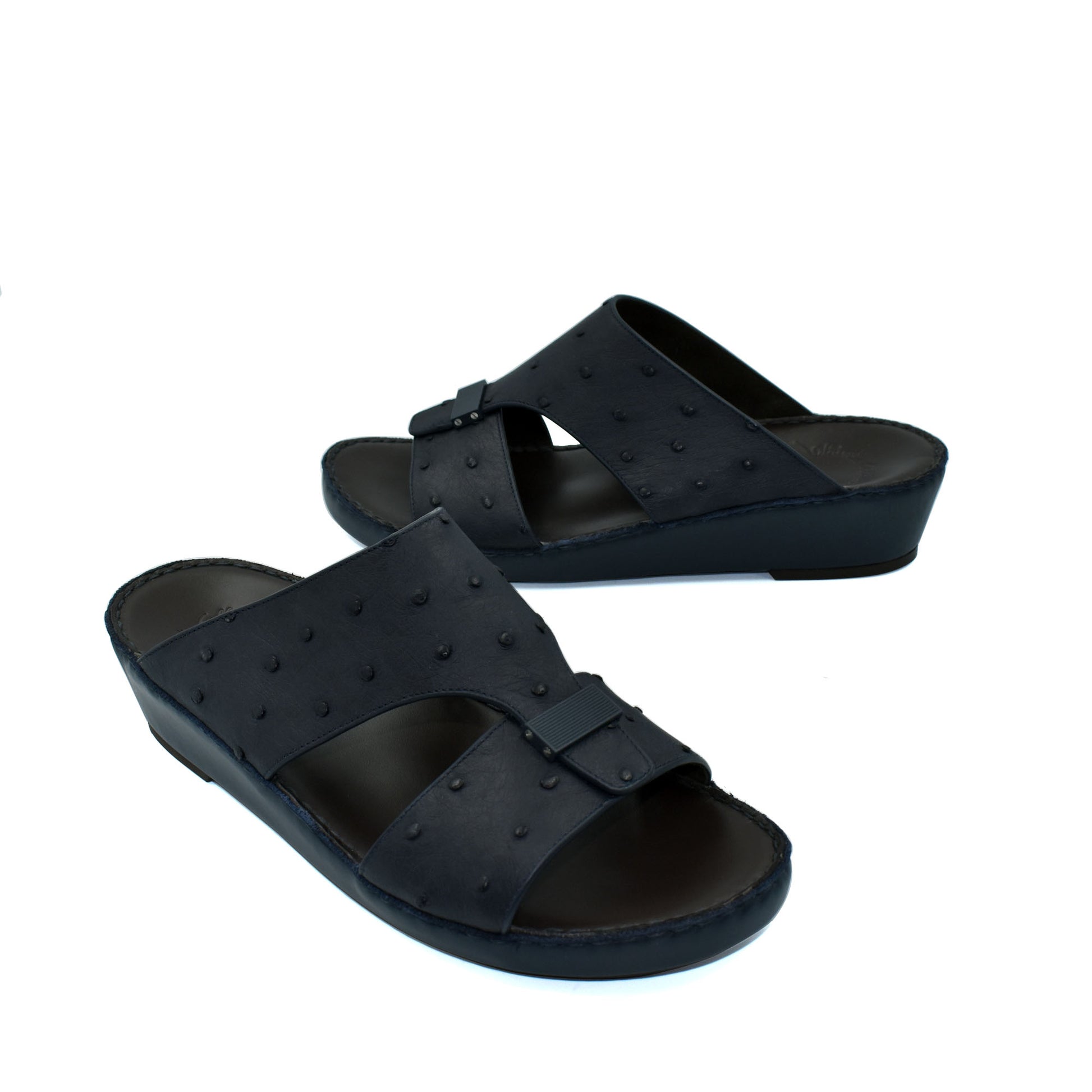 Black ostrich leather sandals with buckle detail and comfortable wedge sole