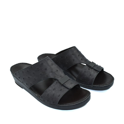 Black ostrich leather sandals with open toe and slip-on design for casual comfort