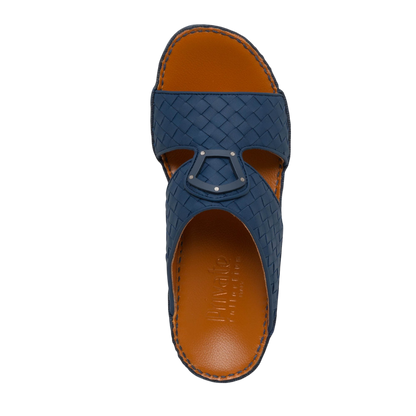 Top view of blue Peninsula Classica Trecce sandals with woven leather design and brown insole