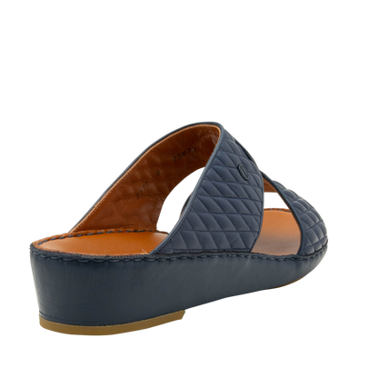 Navy Peninsula Lamb Matelasse sandals with quilted straps and cushioned brown footbed