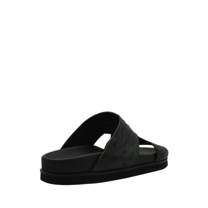 Black premium ostrich leather footwear slide sandal with textured leather upper and cushioned sole