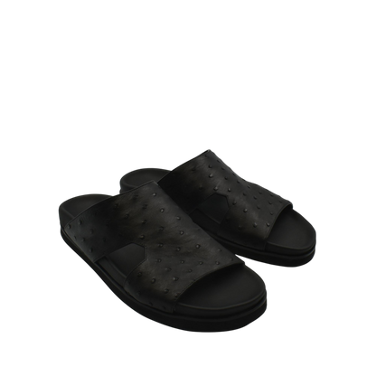 Black slip-on premium ostrich leather footwear sandals with textured upper and cushioned sole