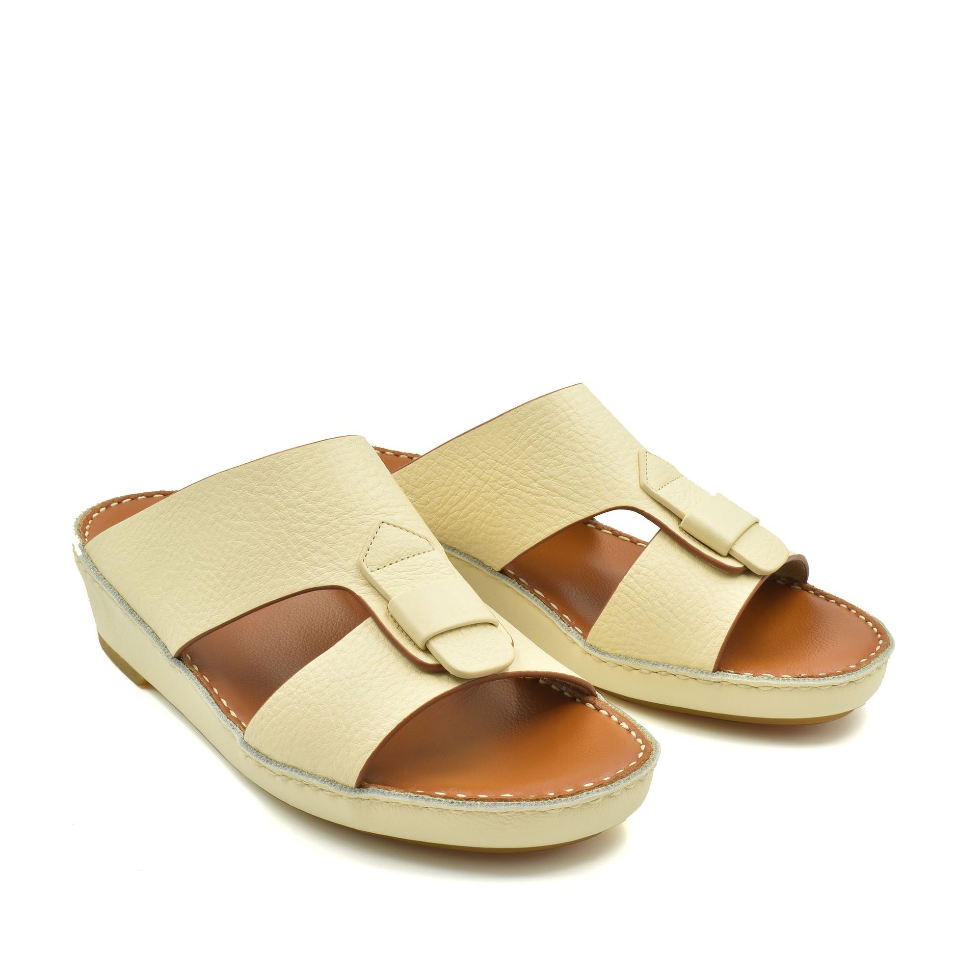 Cream color granulato leather footwear slides with adjustable strap and cushioned sole