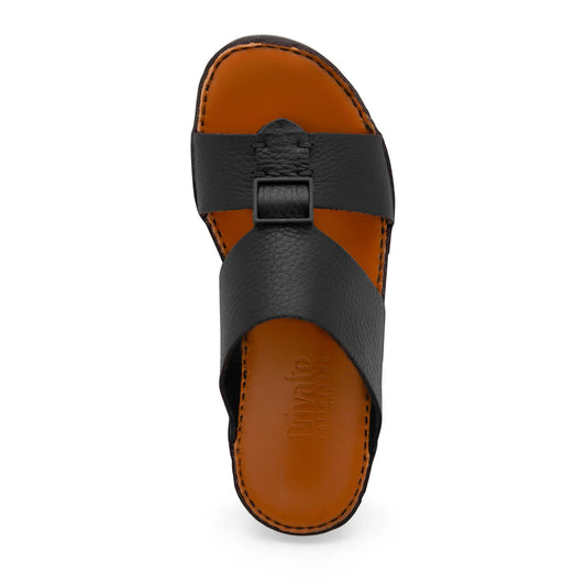 Black luxury leather sandals with wide straps and brown cushioned footbed from Private Collection