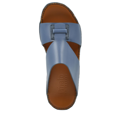 Top view of blue luxury leather sandals with stitched brown sole from Private Collection