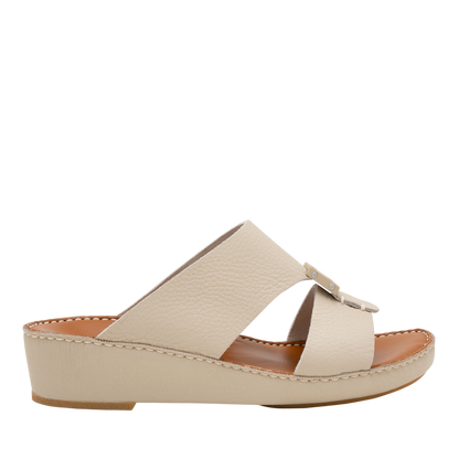 Beige luxury leather sandals with crisscross straps and low wedge heel from Private collection