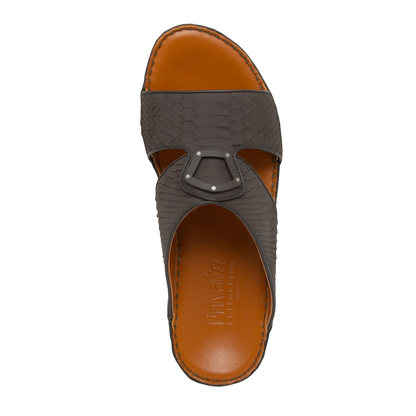 Top view of luxury python sandals with brown leather sole and dark textured snake skin straps