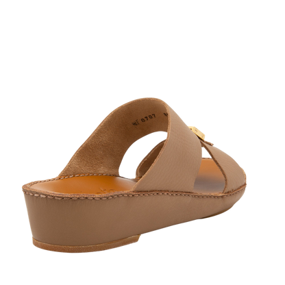 Beige metallic deercalf slides with a low wedge heel and gold buckle detail from Private Collection