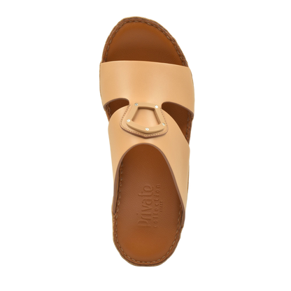 Tan natural leather slide shoes from Private Collection with decorative metal buckle detail