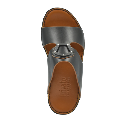 Top view of natural leather slide shoes with brown cushioned footbed and gray strap from Private collection