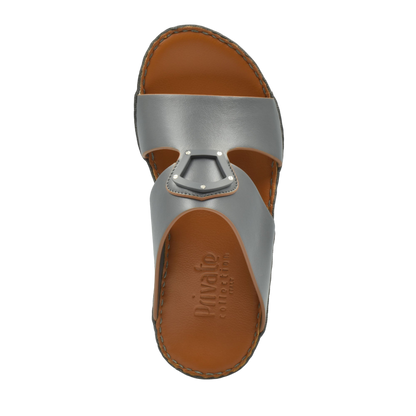 Top view of natural leather slide shoes in gray with brown footbed from Private collection
