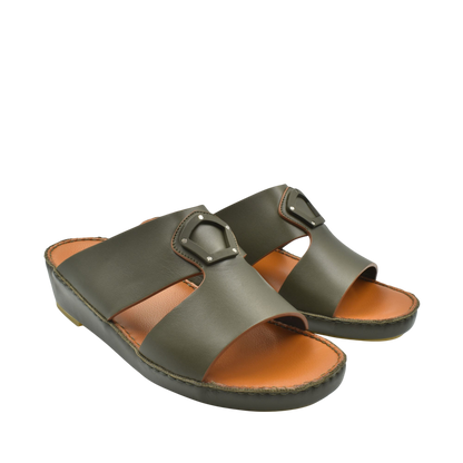 Pair of olive green natural leather slide shoes with cushioned tan footbed and stitched sole