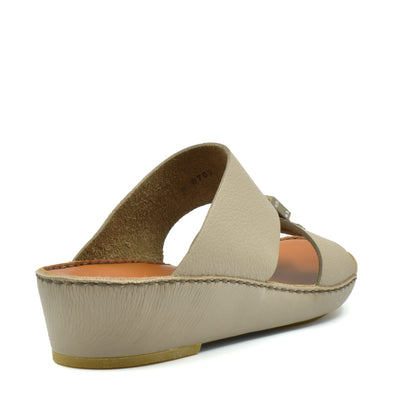 Beige classic leather sandals with low wedge heel and open toe design from Private Collection